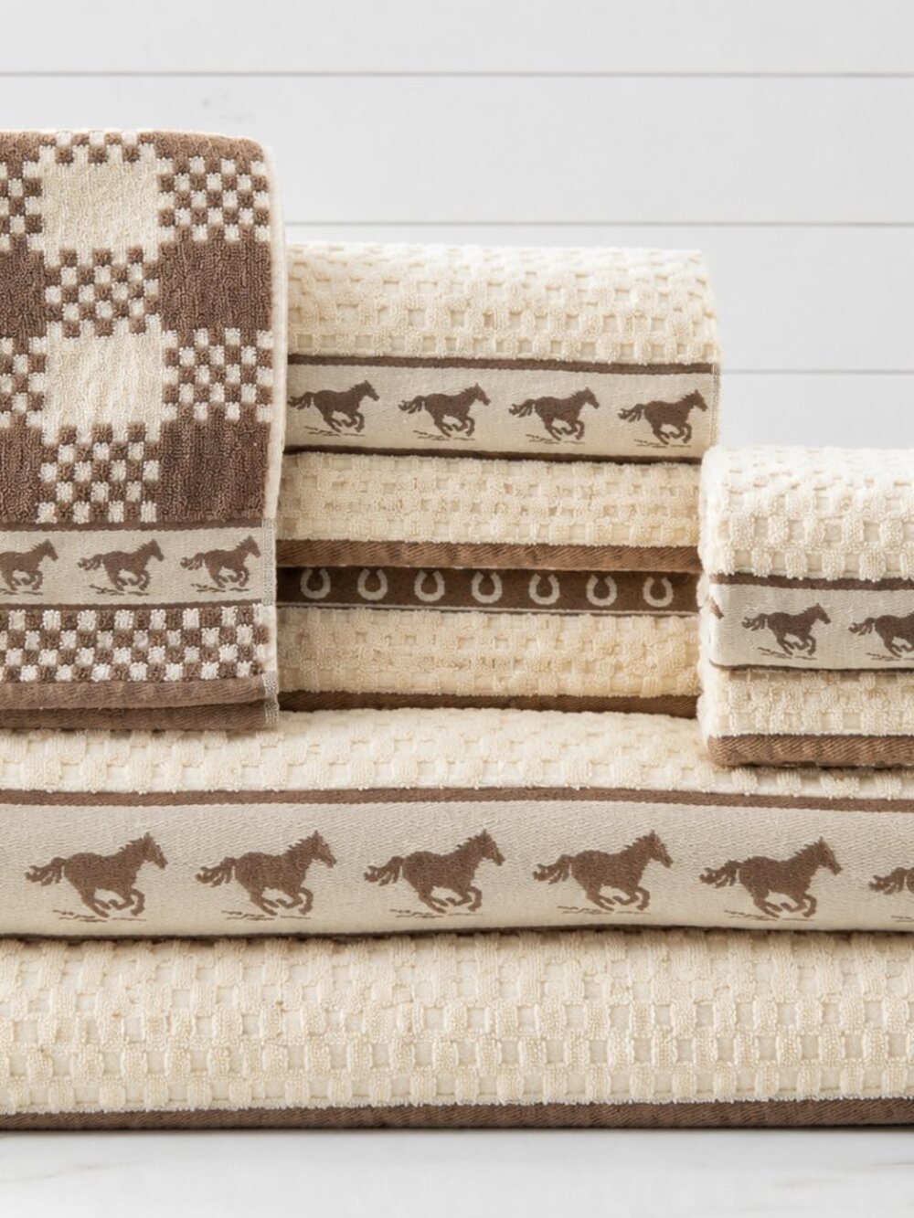 Cozy western-themed towel set in cream and brown with running horse/horseshoe
